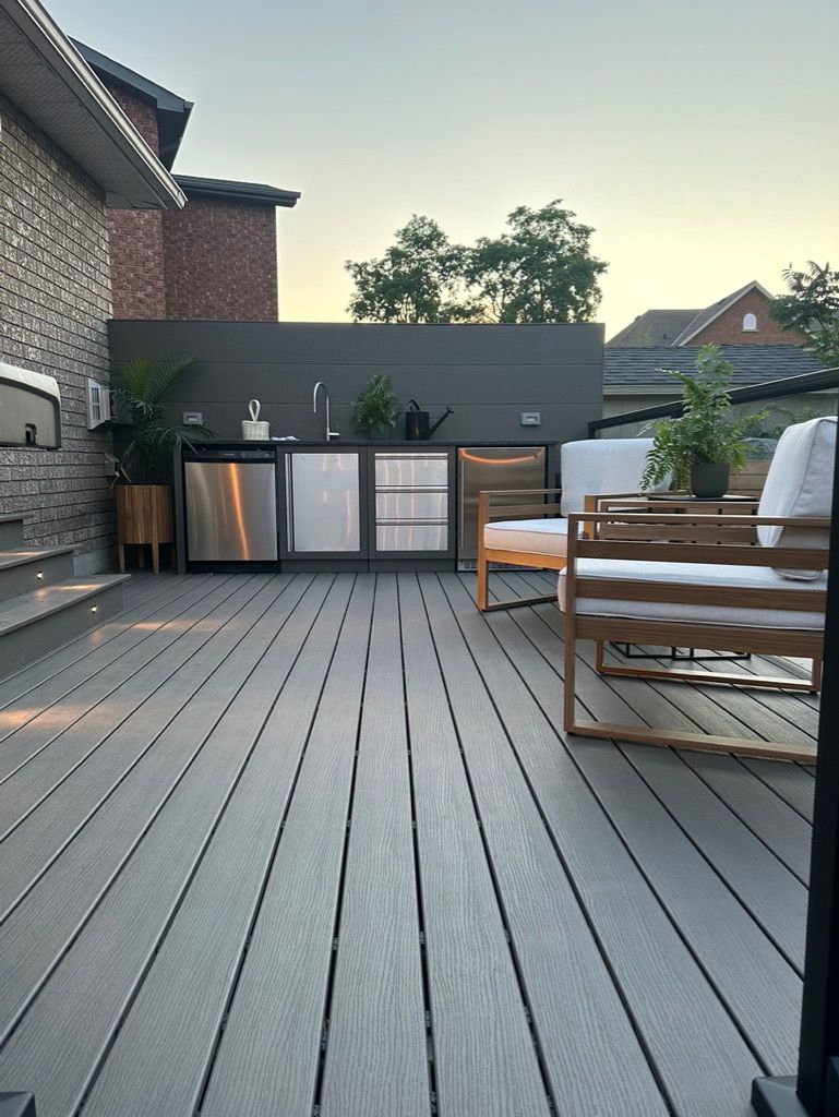 Full view of a custom composite deck with integrated outdoor kitchen.