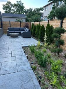 Modern patio with a fire bowl and privacy fence in Paris, ON.