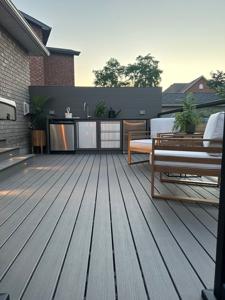 Composite deck with a built-in outdoor kitchen in Brant County.